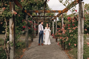 image shows  couple standing in the garden