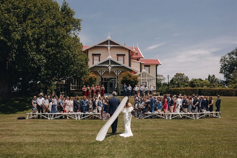 people having a wedding ceremony in front of a historical building