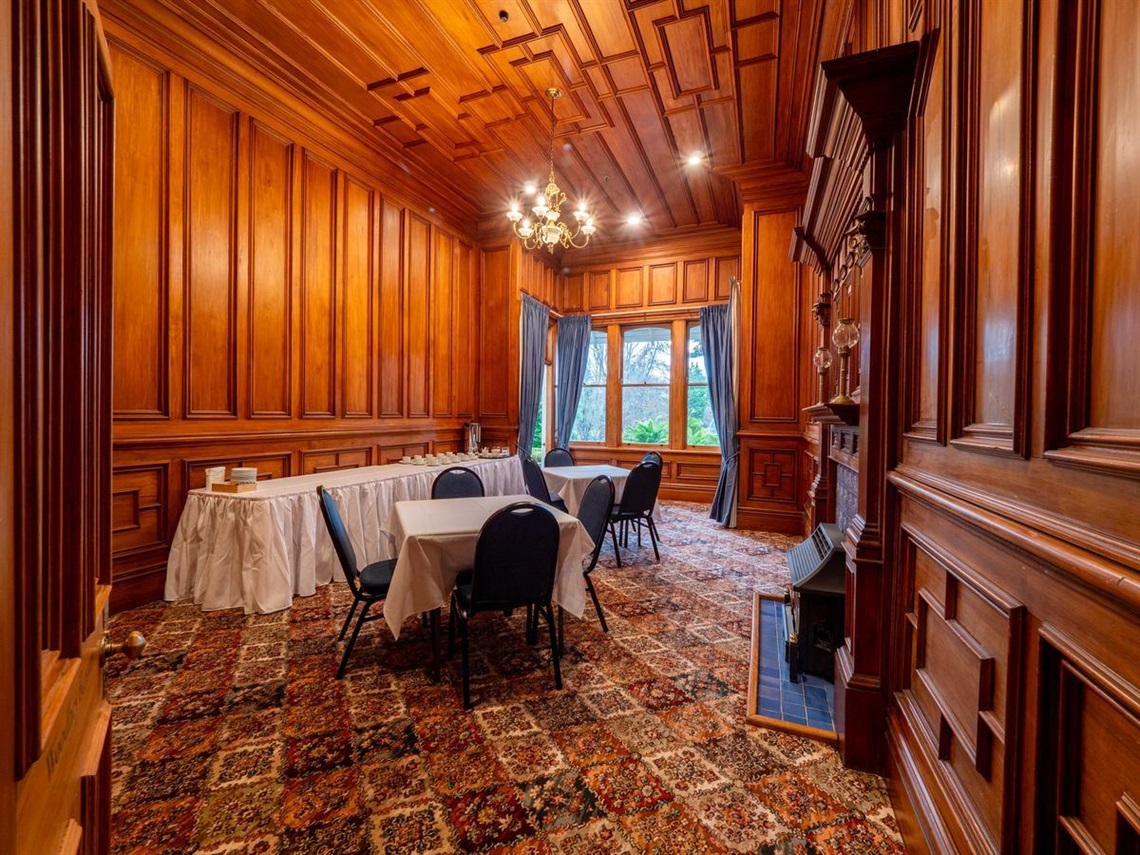 image shows a meeting room with carpet and screen in it